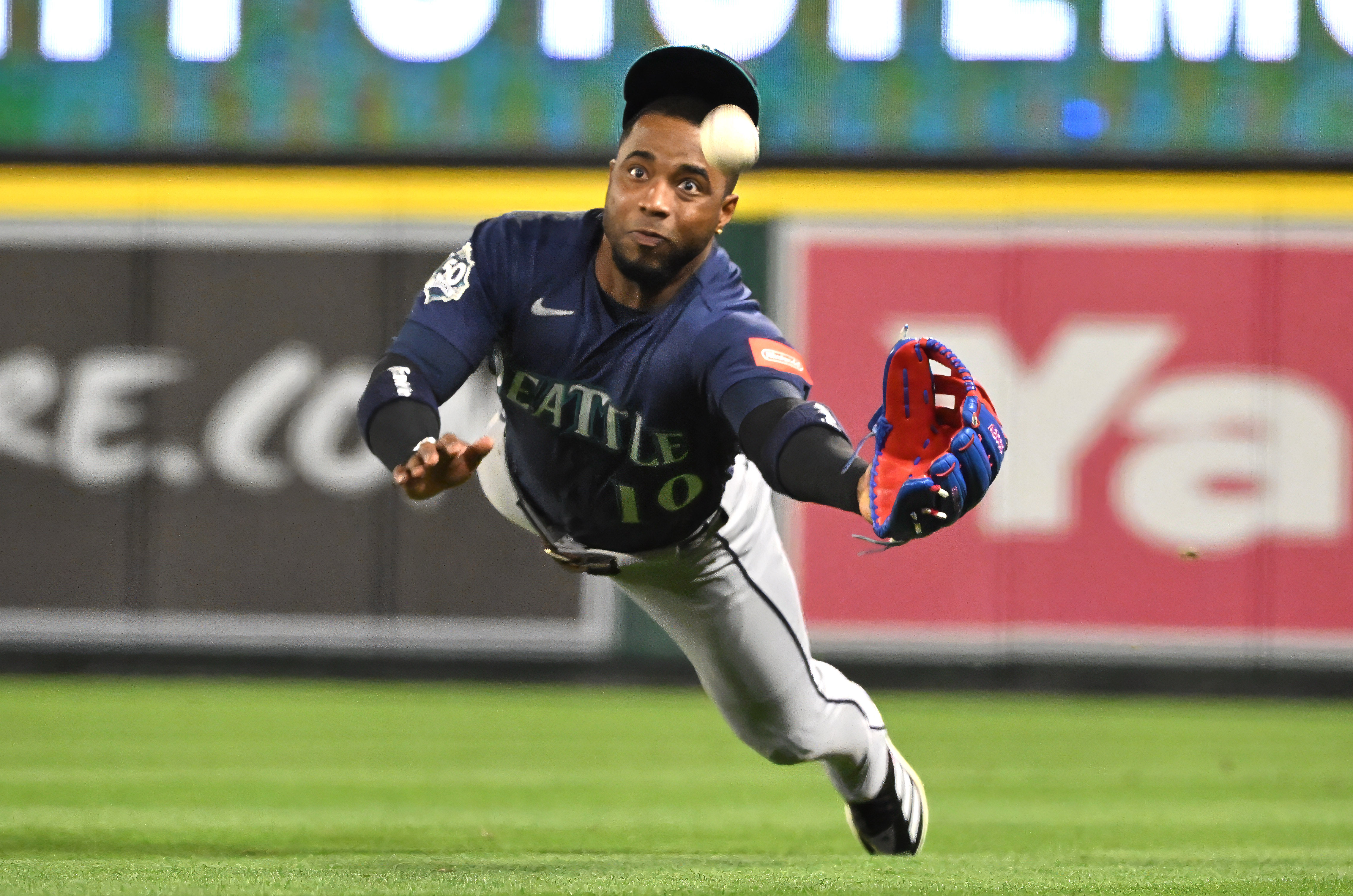 Right fielder Victor Robles #10 of the Seattle Mariners dives,...