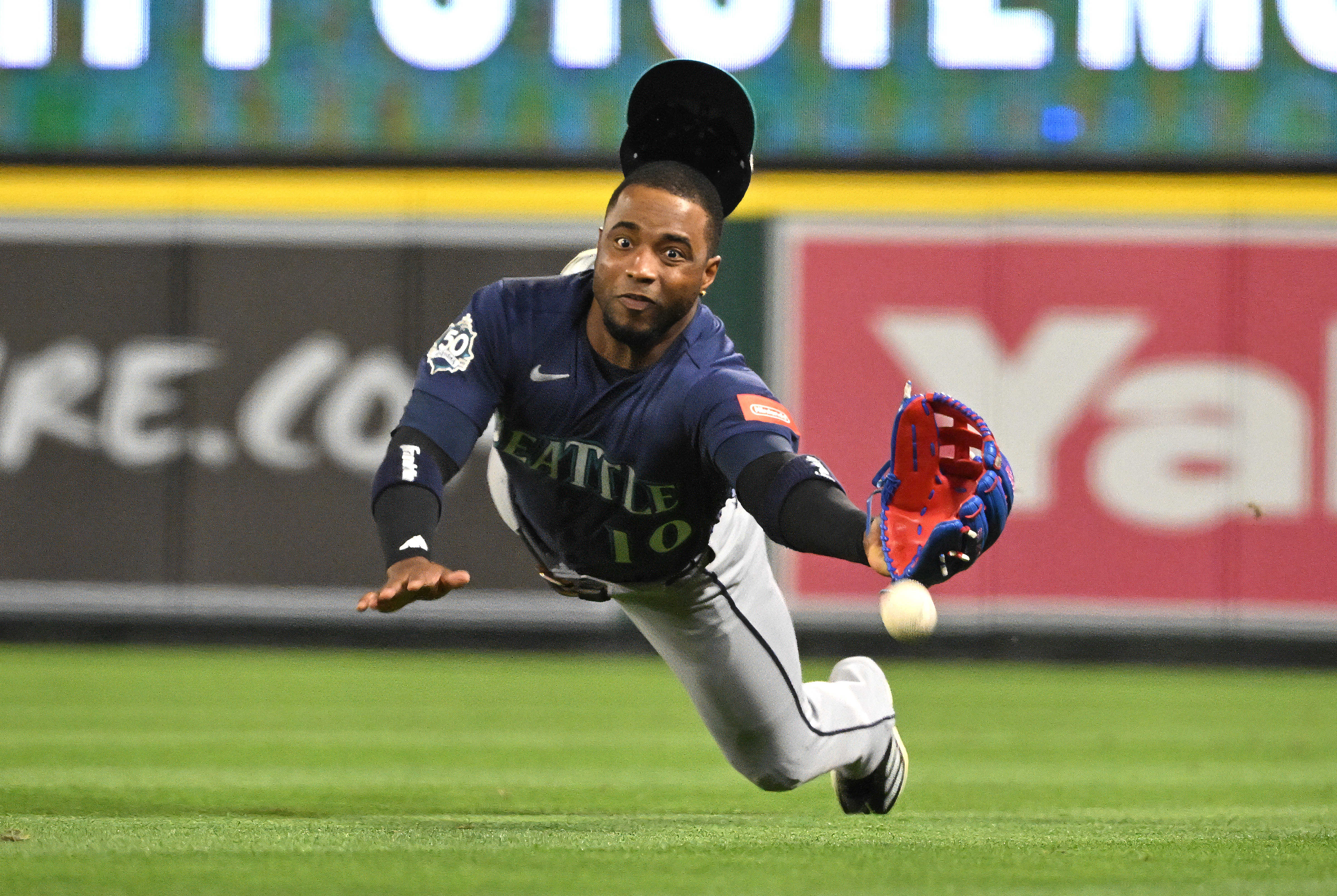 Right fielder Victor Robles #10 of the Seattle Mariners dives,...