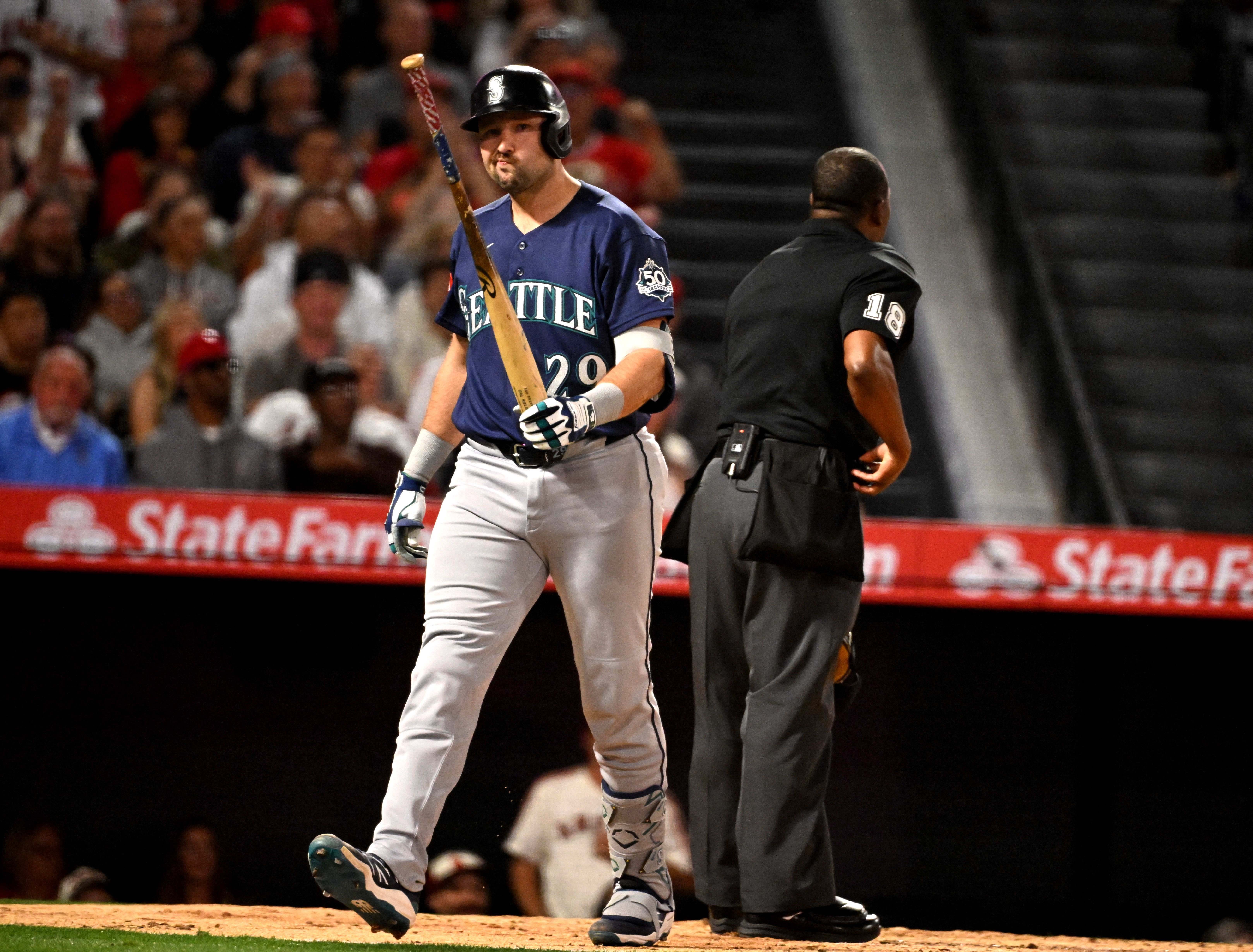 Cal Raleigh #29 of the Seattle Mariners reacts after striking...