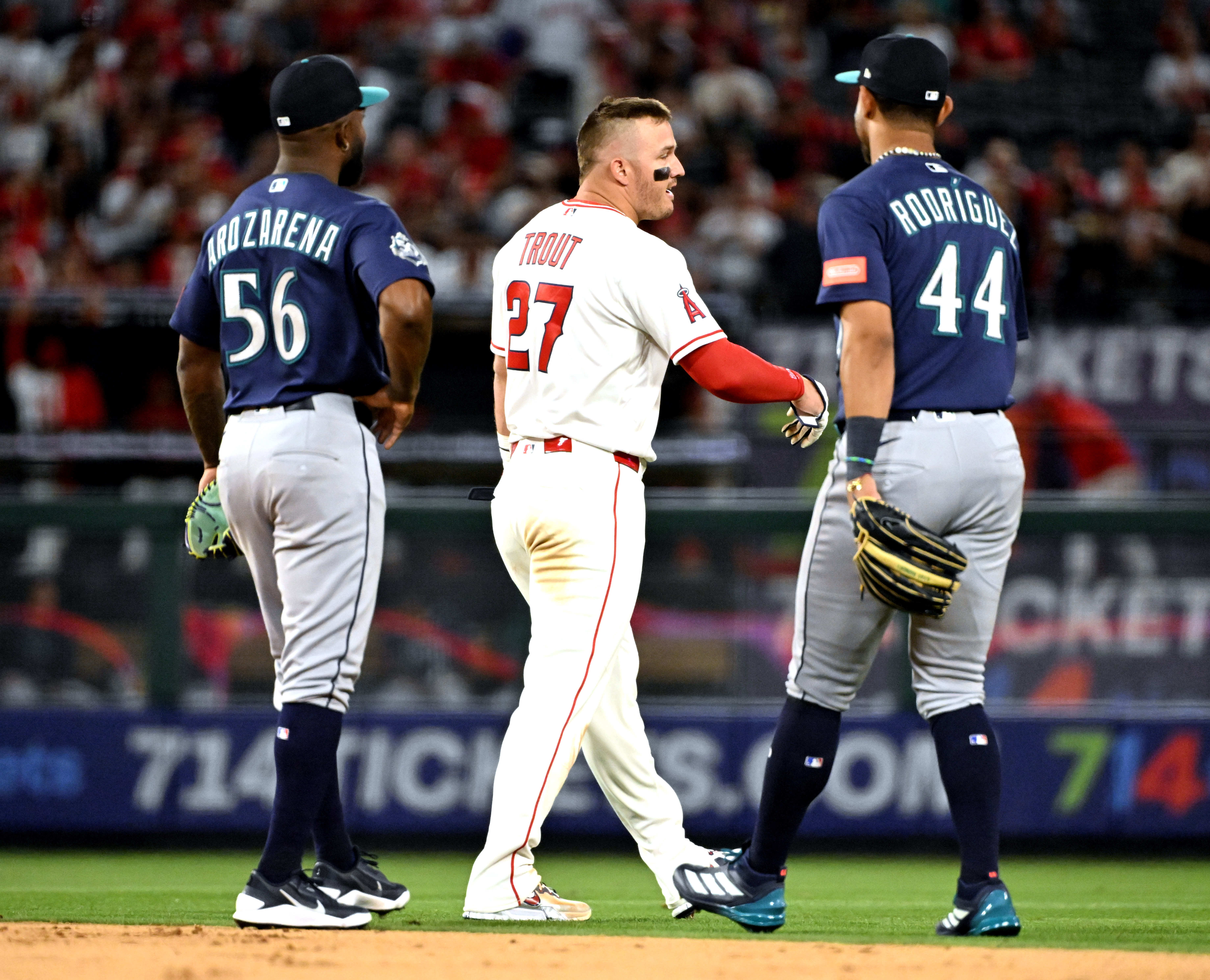 Mike Trout #27 of the Los Angeles Angels talks with...