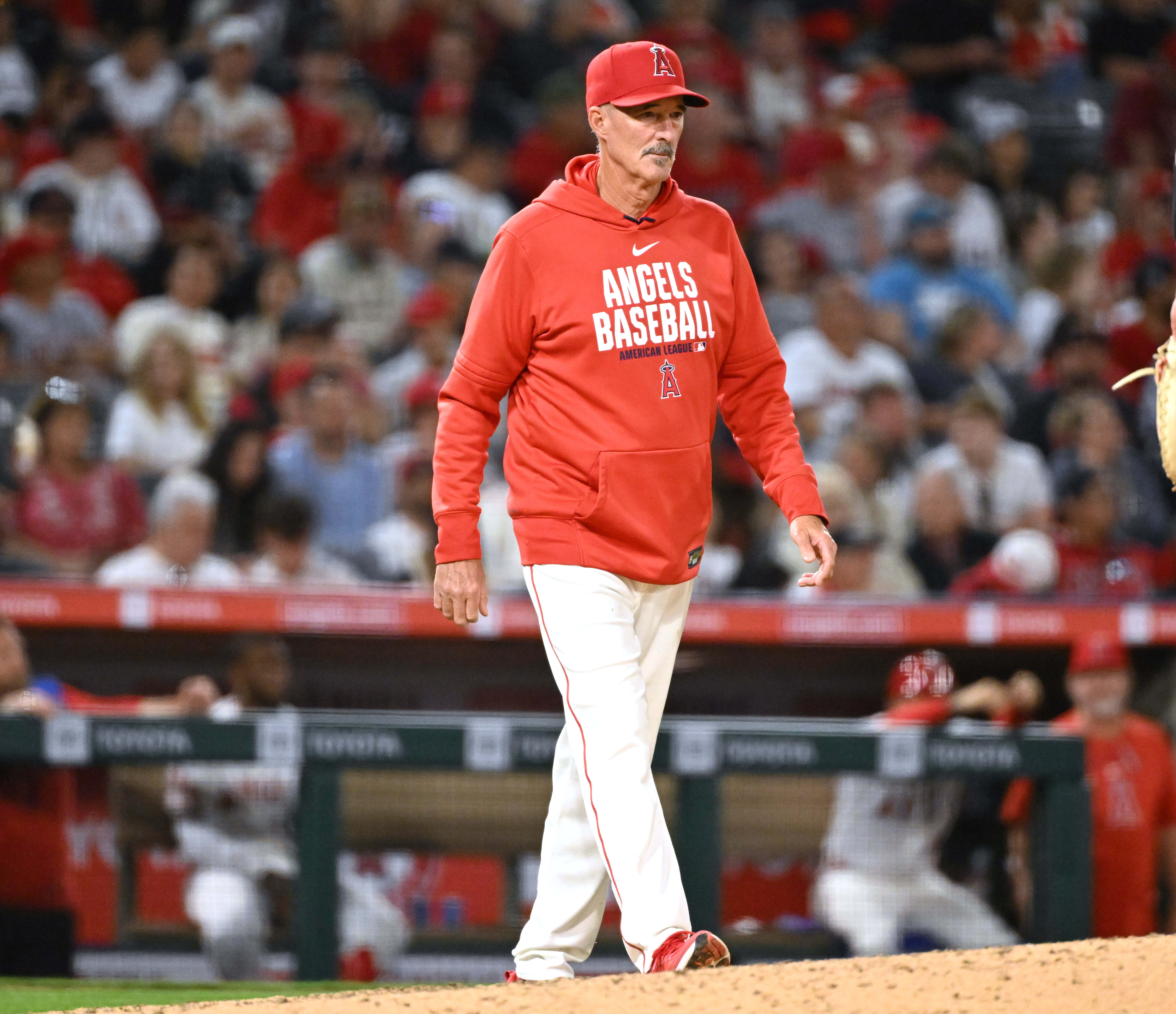 Angels pitching coach Mike Maddux walks toward the mound during...