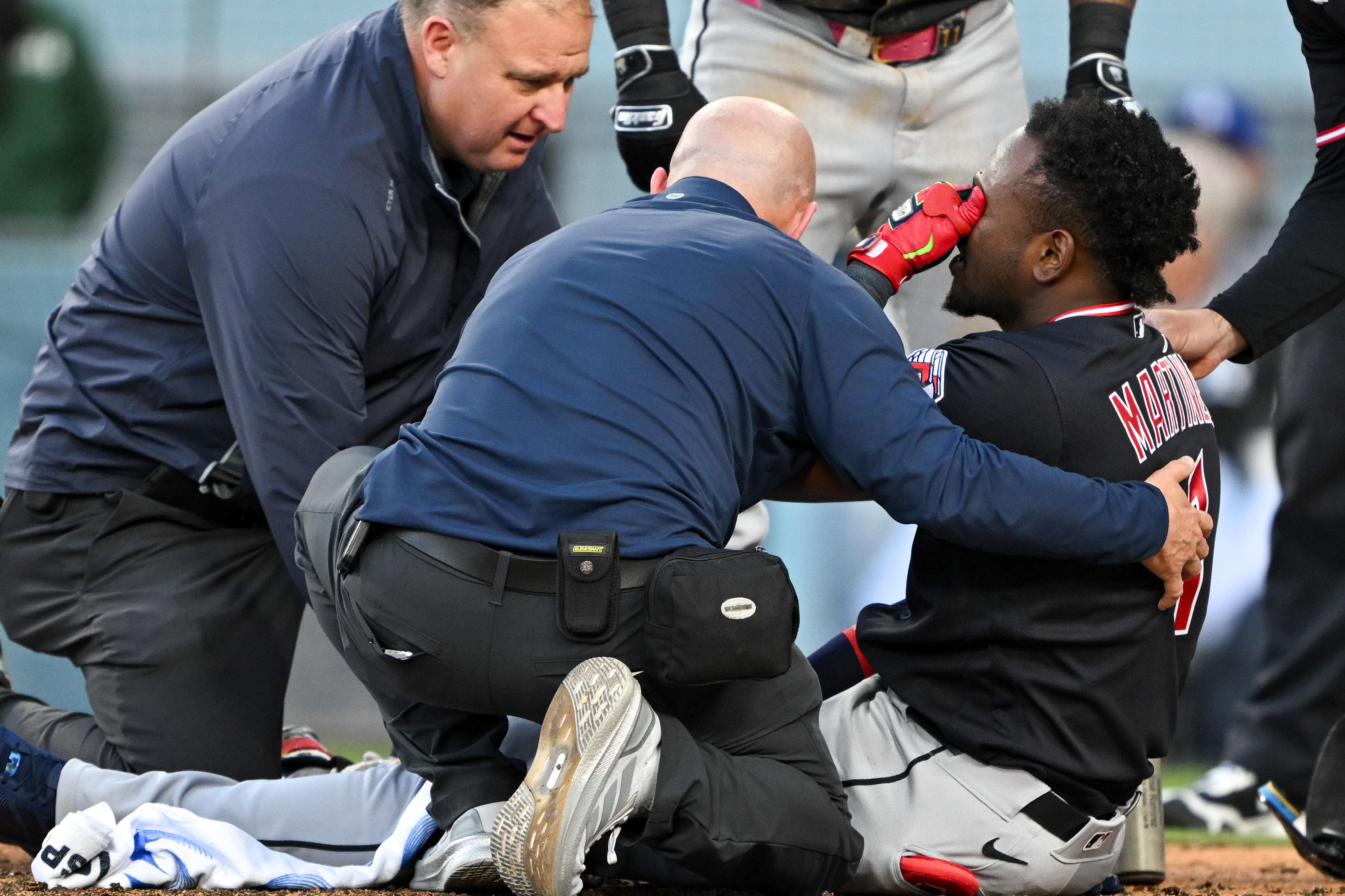 The Cleveland Guardians’ Angel Martinez is tended to by trainers...