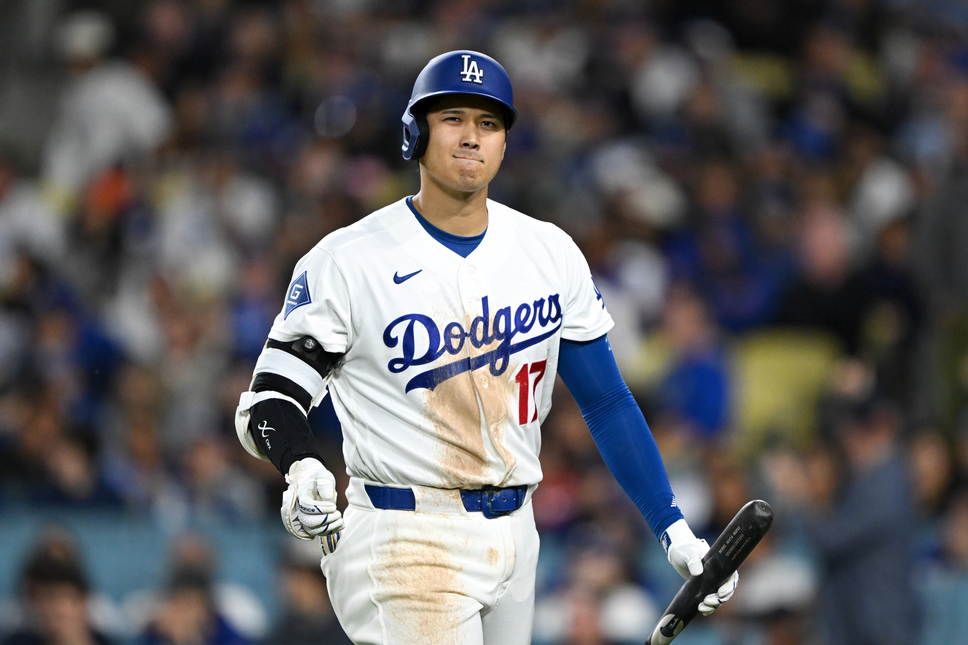 Dodgers star Shohei Ohtani walks back to the dugout after...