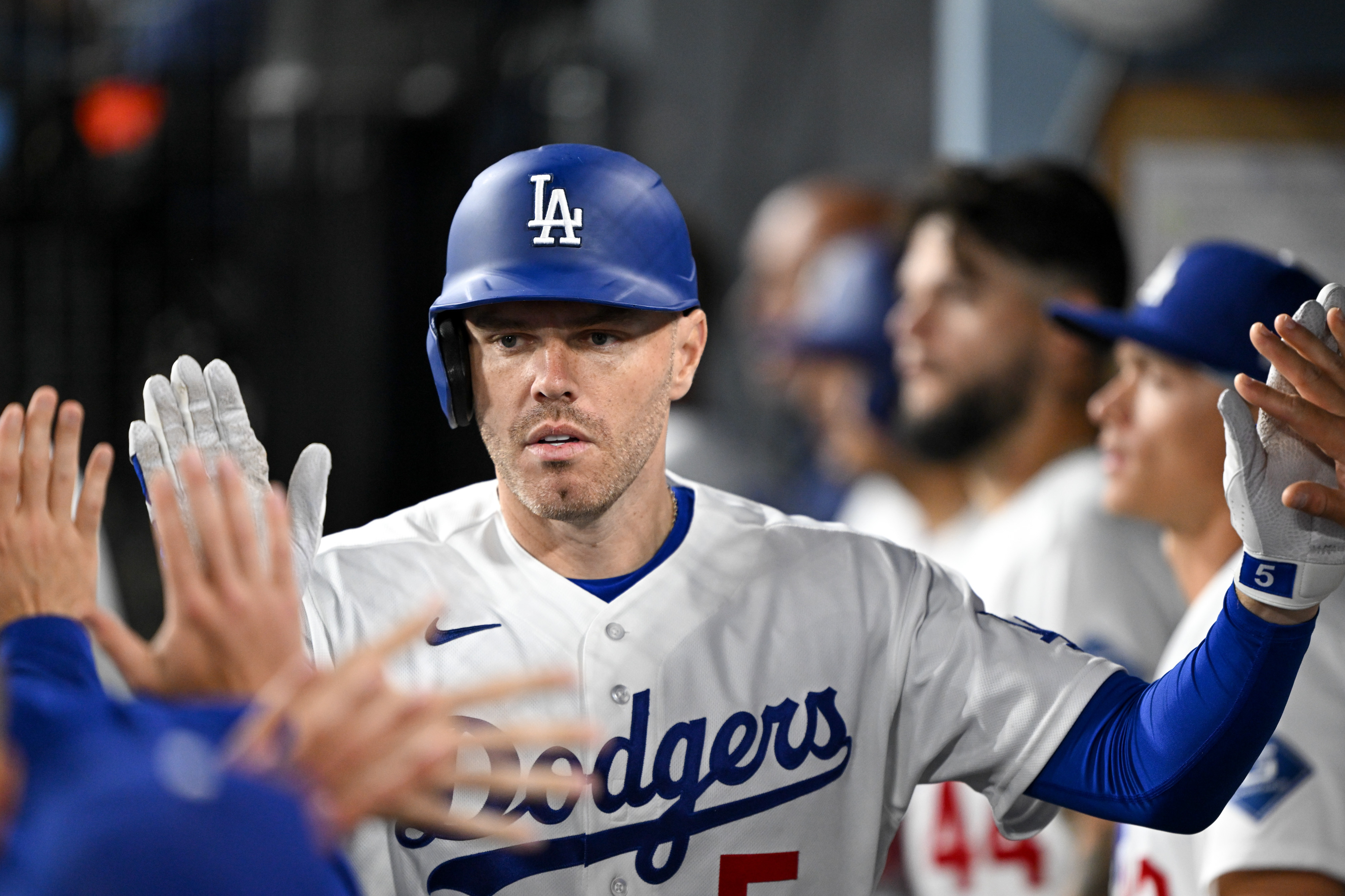 The Dodgers’ Freddie Freeman is greeted by teammates in the...