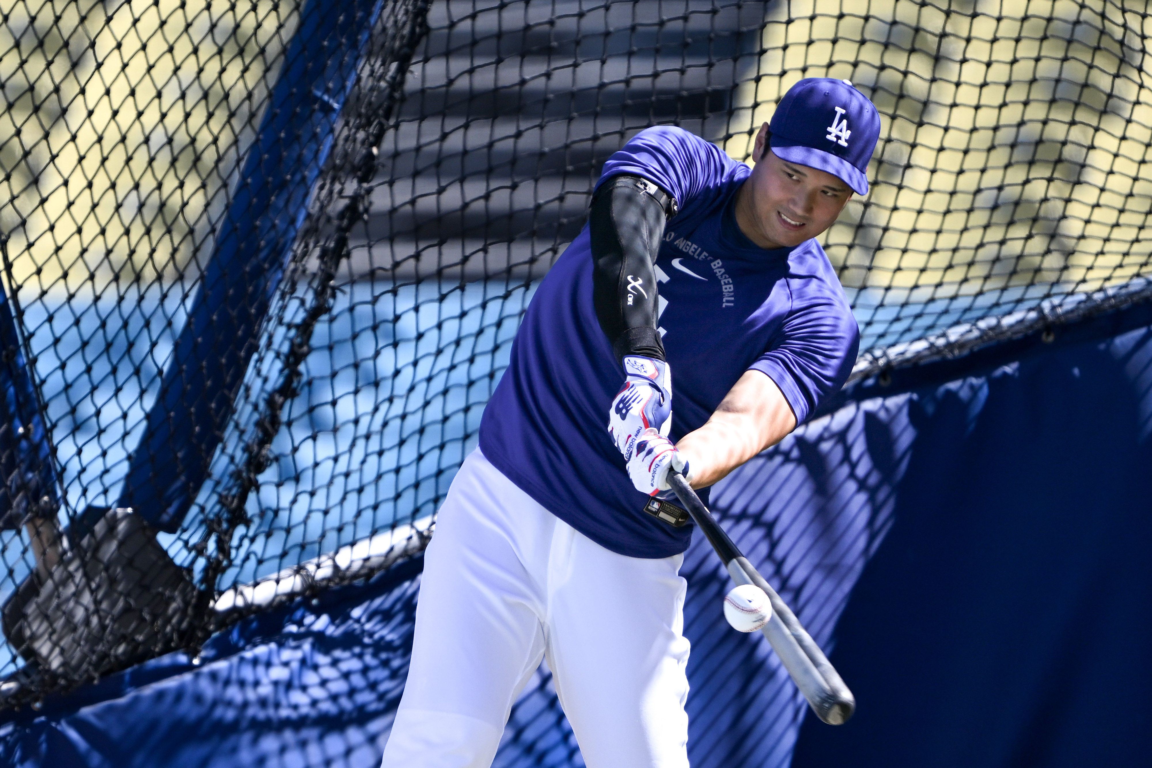 Dodgers star Shohei Ohtani takes batting practice before a game...