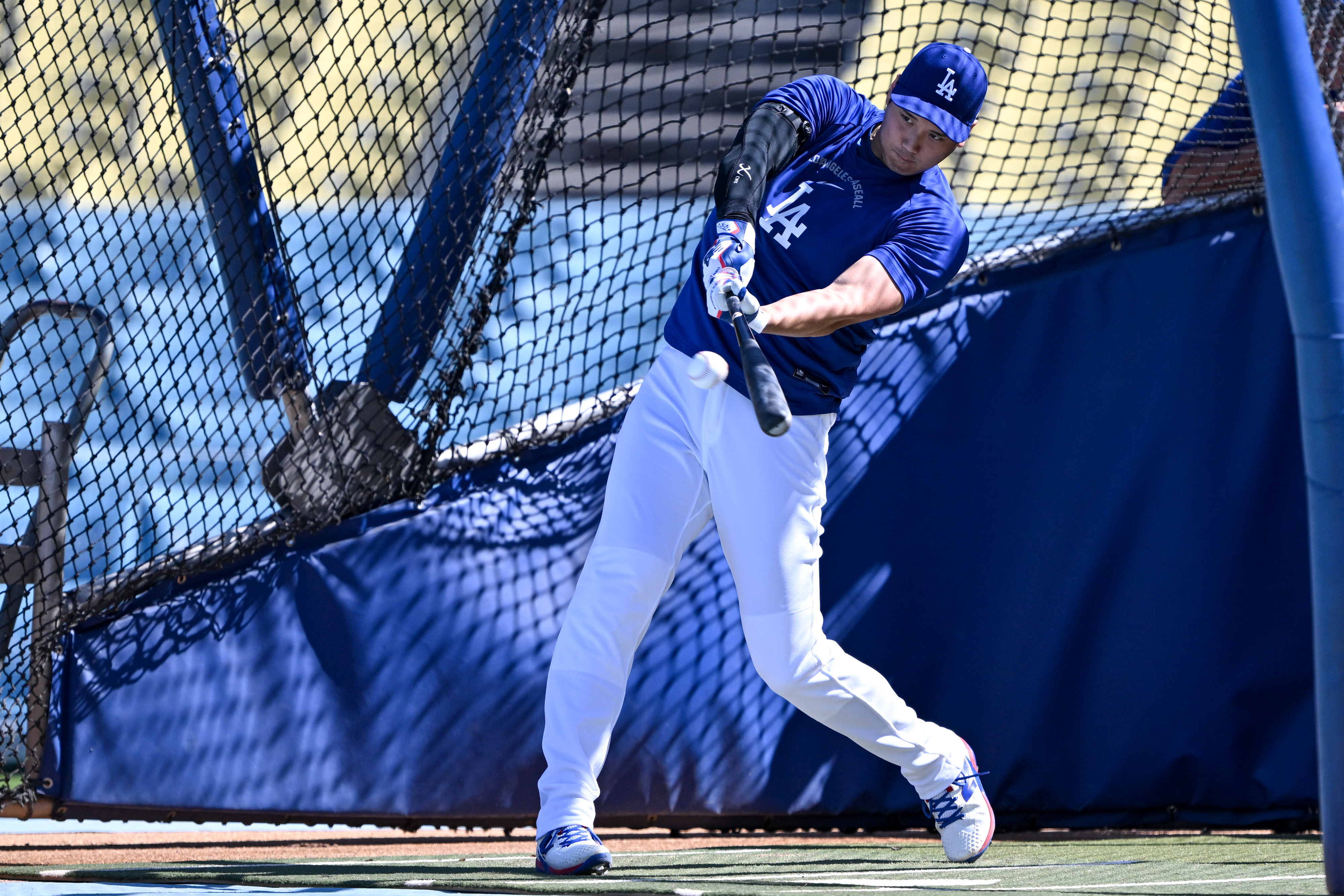 Dodgers star Shohei Ohtani takes batting practice before a game...