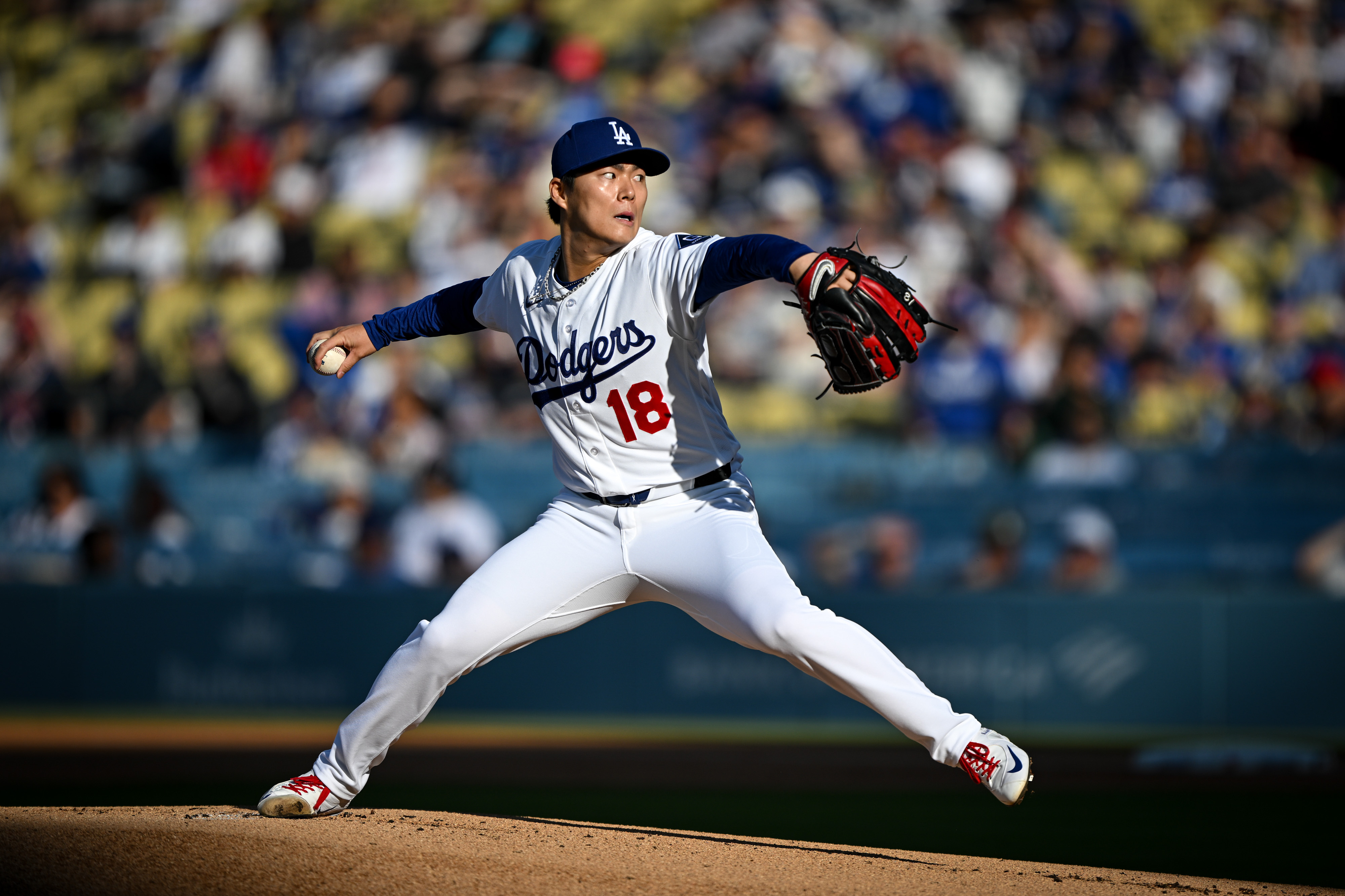 Dodgers starting pitcher Yoshinobu Yamamoto throws to the plate during...