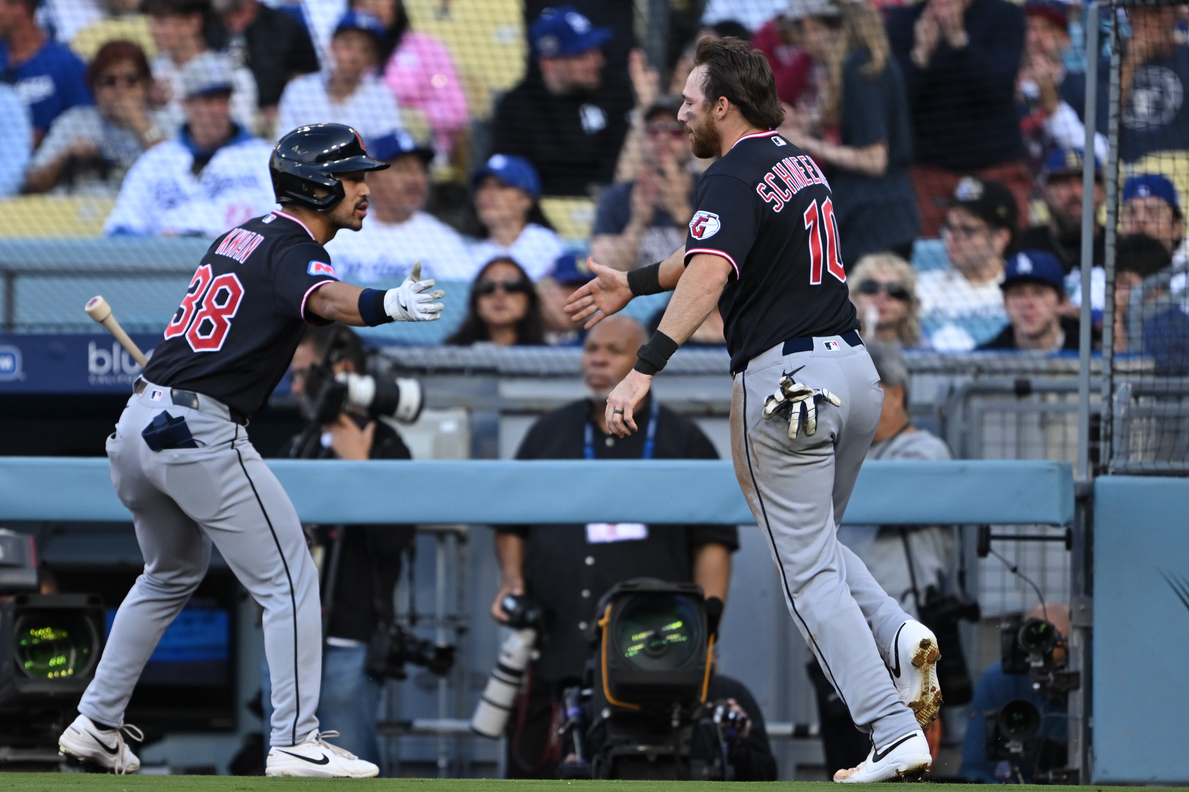 The Cleveland Guardians’ Daniel Schneemann, right, celebrates as he returns...