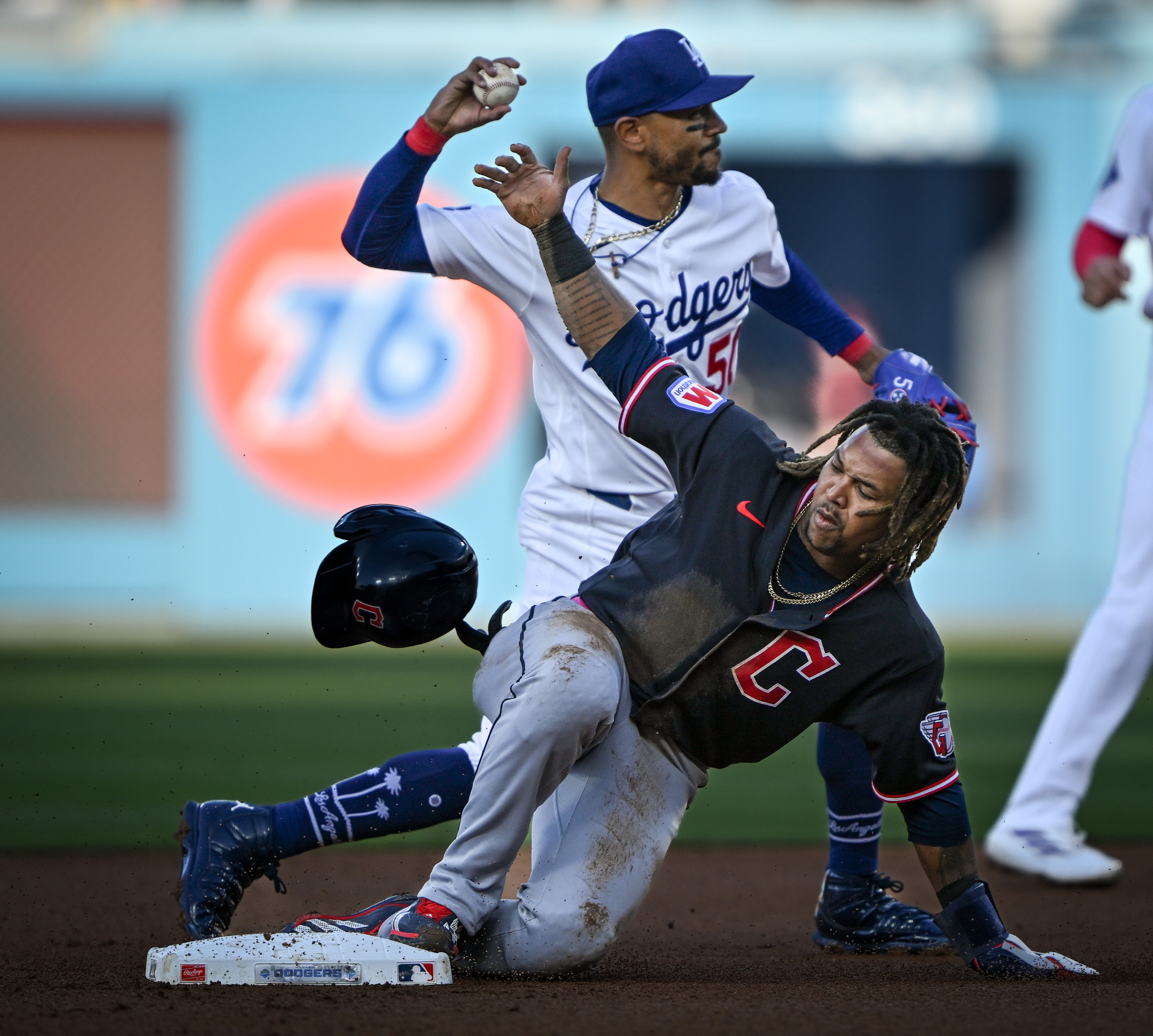 Dodgers shortstop Mookie Betts, top, throws to first base to...