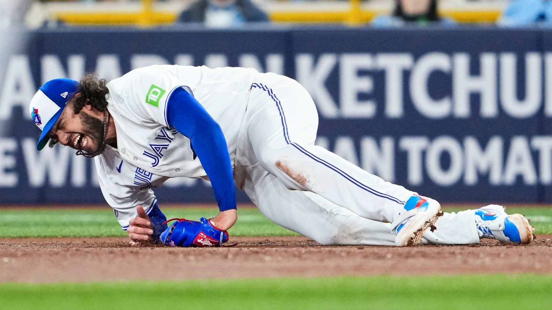 TORONTO, CANADA - MARCH 30: Cody Ponce #66 of the Toronto Blue Jays falls to the ground with an injury during the third inning in their MLB game against the Colorado Rockies at the Rogers Centre on March 30, 2026 in Toronto, Ontario, Canada. (Photo by Mark Blinch/Getty Images)