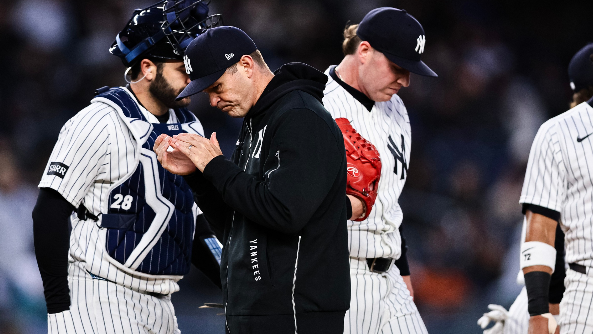 Aaron Boone walks back to the dugout after a mound visit with Ryan Weathers #40 of the New York Yankees during the first inning against the Miami Marlins at Yankee Stadium on April 04, 2026 in New York City. (Photo by Caean Couto/Getty Images)