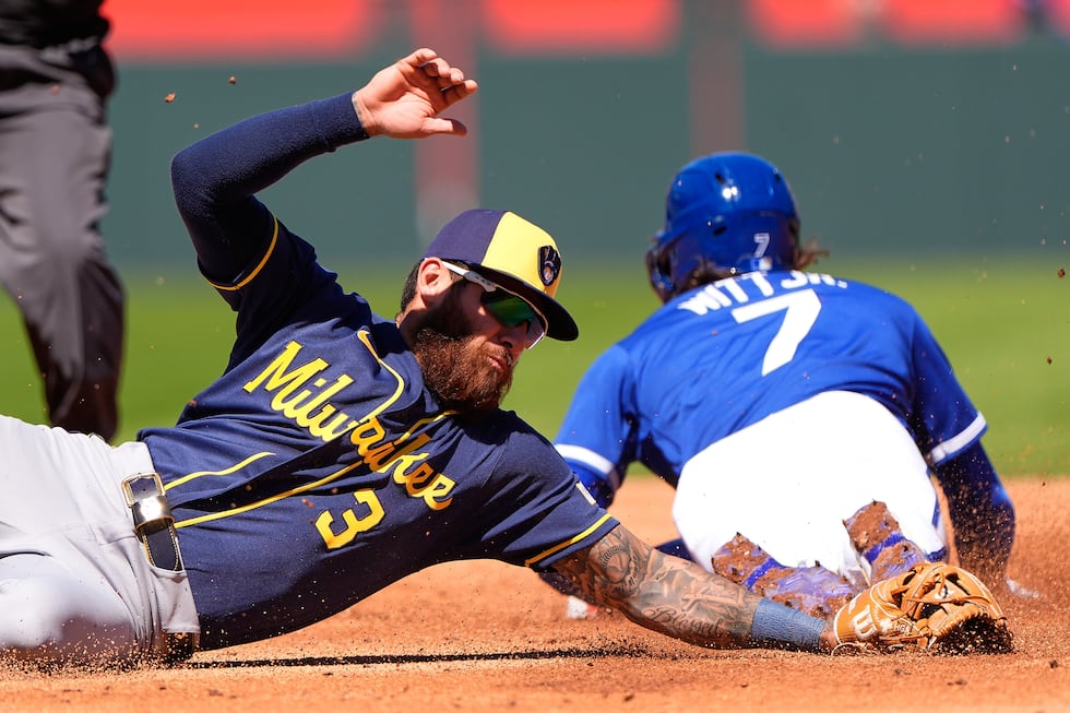 Kansas City Royals' Bobby Witt Jr. (7) beats the tag by Milwaukee Brewers shortstop Joey Ortiz...