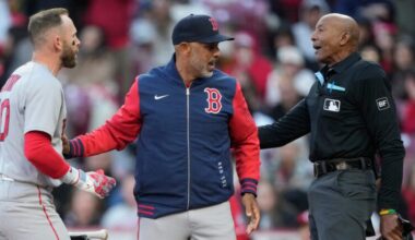 Boston Red Sox manager Alex Cora, center, and Boston Red Sox's Trevor Story, left, dispute a call with home plate umpire CB Bucknor before Cora is ejected during the eighth inning of a baseball game against the Cincinnati Reds in Cincinnati, Saturday, March 28, 2026.