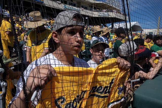 Rocco Sansieir, visiting from New Jersey, tries to get a player’s autograph before the Athletics played the Houston Astros on Saturday at Sutter Health Park in West Sacramento.