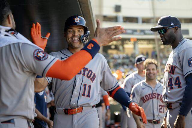 Houston Astros batter Cam Smith is greeted by teammates after hitting a solo home run against the Athletics in the eighth inning Saturday at Sutter Health Park in West Sacramento.