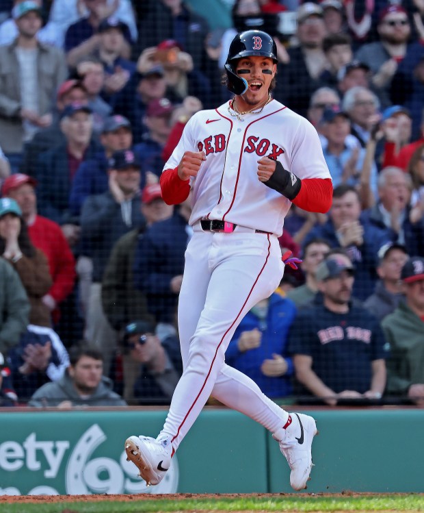 Boston Red Sox left fielder Jarren Duran celebrates as he scores on a hit by Boston Red Sox third baseman Caleb Durbin in the fourth inning as the Red Sox take on the Padres in the home opener at Fenway Park. (staff photo by Stuart Cahill/MNG)
