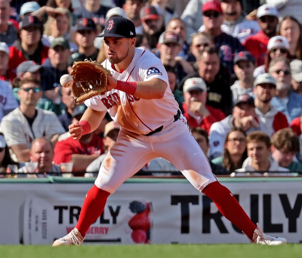 Boston Red Sox third baseman Caleb Durbin fields a grounder by San Diego Padres shortstop Xander Bogaerts in the sixth inning as the Red Sox take on the Padres during the home opener at Fenway Park. (staff photo by Stuart Cahill/MNG)