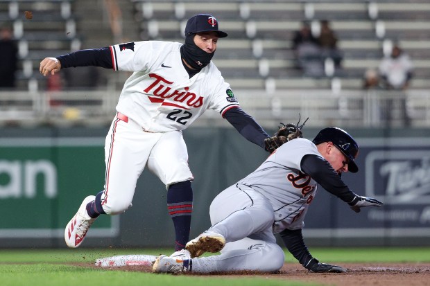 Minnesota Twins shortstop Brooks Lee, left, tags out Detroit Tigers' Spencer Torkelson (20) who was attempting to steal second base during the eighth inning of baseball game Monday, April 6, 2026, in Minneapolis. (AP Photo/Matt Krohn)
