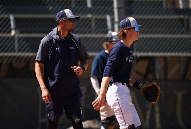 Former Rockies pitcher Jason Hirsh, left, is now the head coach of Mullen High School's baseball program. Hirsh coaches practice at the high school's field on April 02, 2026, in Denver. (Photo by RJ Sangosti/The Denver Post)