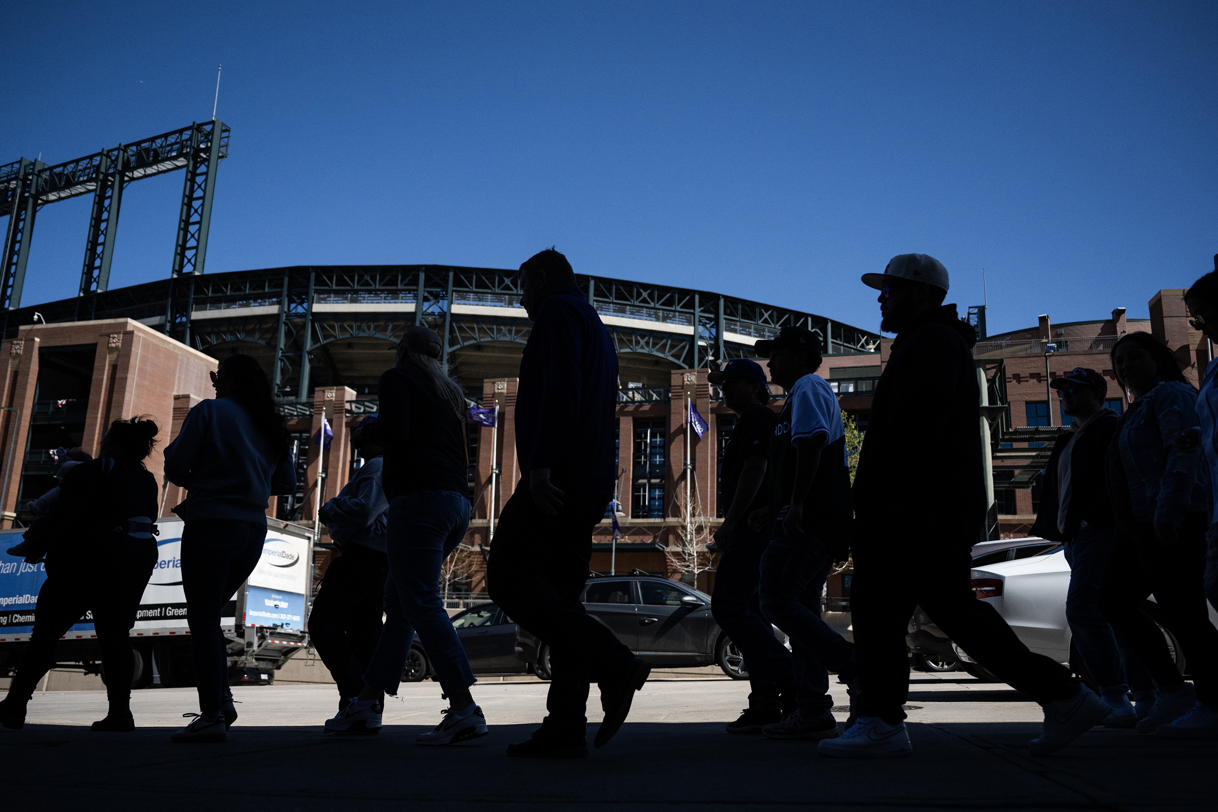 Baseball fans walk down 20th street before the Colorado Rockiesâ...