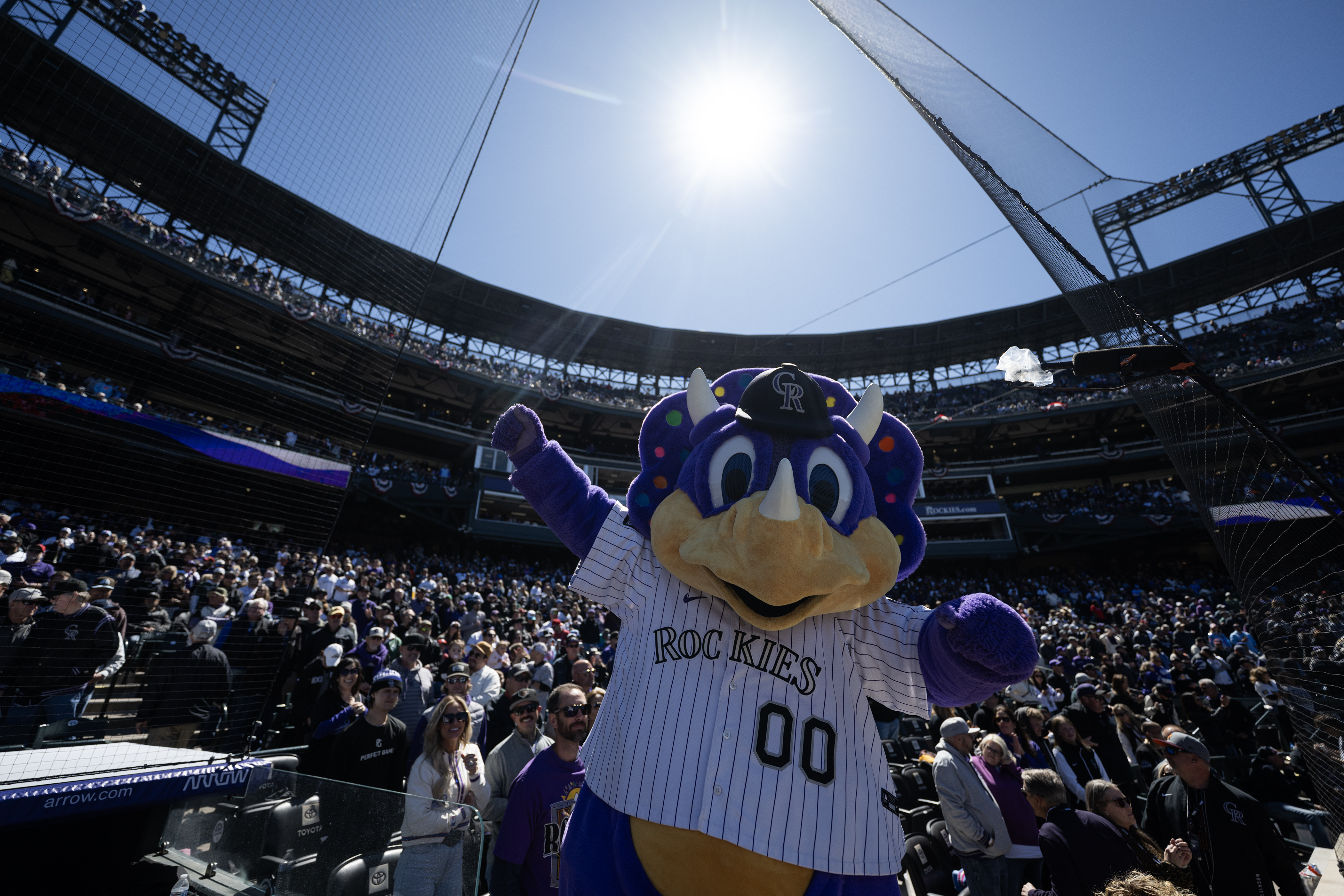 Colorado Rockies mascot Dinger gets the crowd hyped before the...