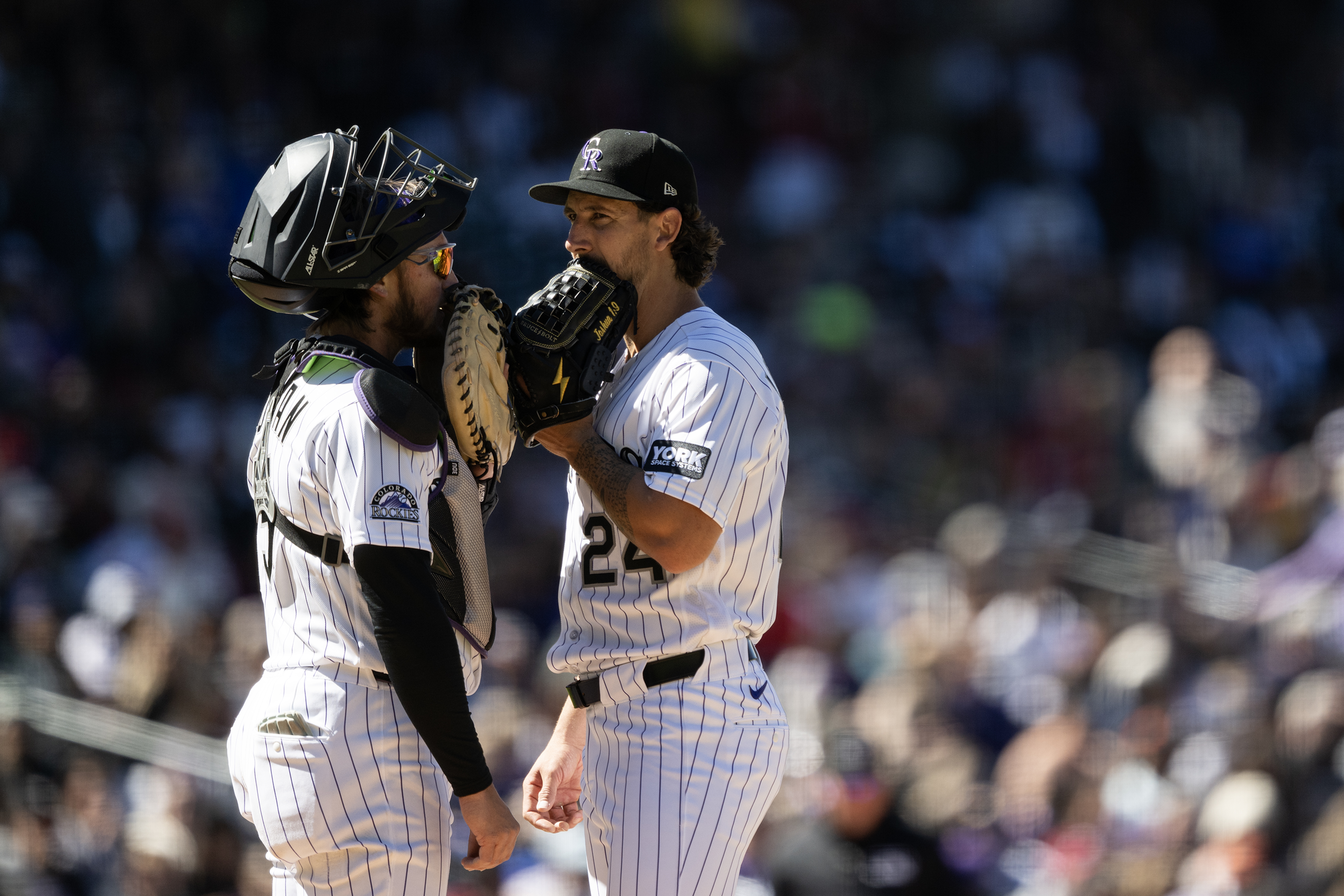 Catcher Hunter Goodman (15) of the Colorado Rockies goes to...