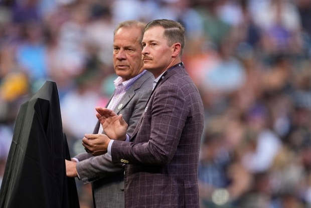 Colorado Rockies vice president of corporate sponsorships Walker Monfort, front, joins his father, the team's owner and chief executive officer, Dick, before a baseball game Saturday, Aug. 17, 2024, in Denver. (AP Photo/David Zalubowski)