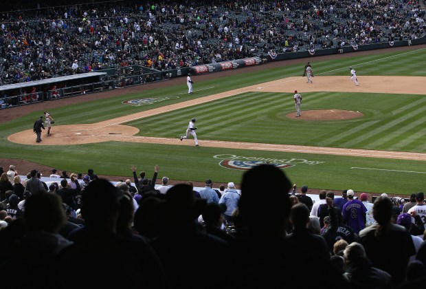 Charlie Blackmon #19 of the Colorado Rockies hits a two RBI double against the Arizona Diamondbacks in the eighth inning during the home opener at Coors Field on April 4, 2014 in Denver. Blackmon went 6 for 6 as the Rockies defeated the Diamondbacks 12-2. (Photo by Doug Pensinger/Getty Images)