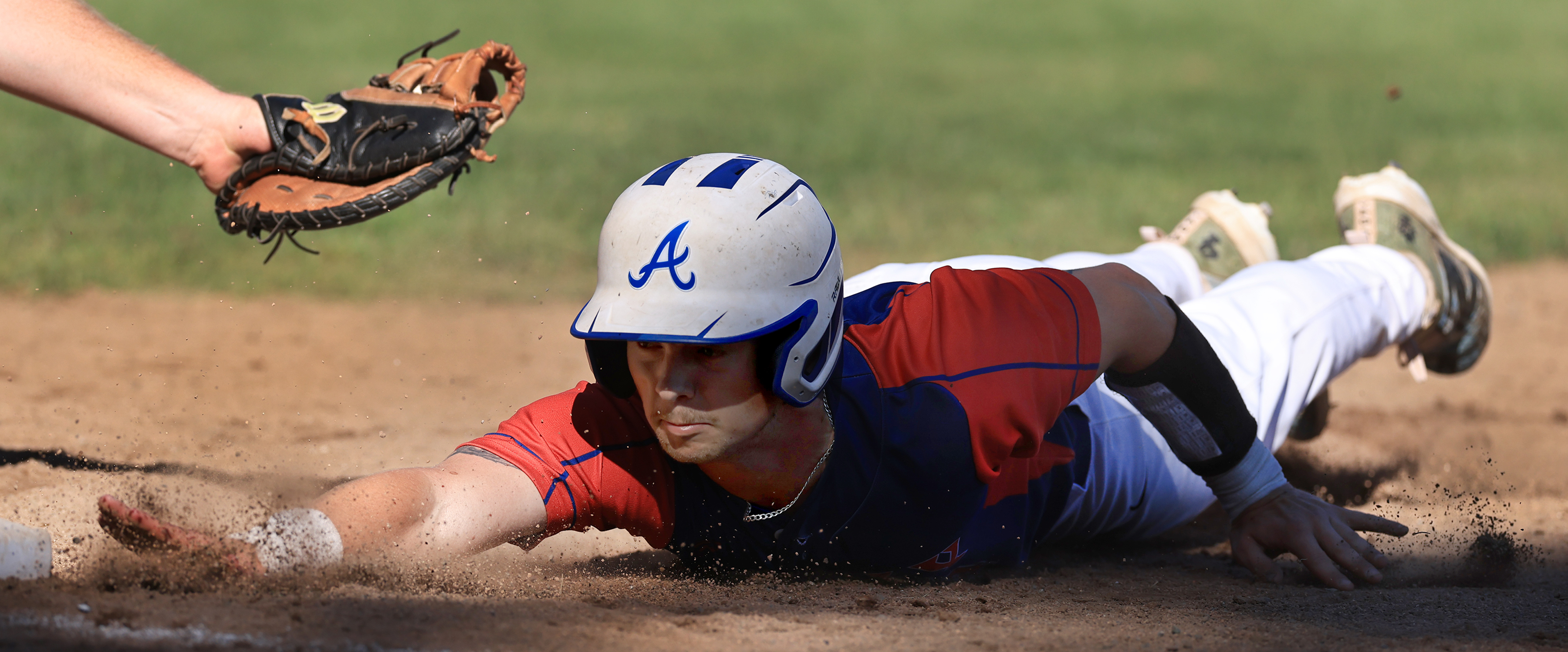 Donnie Rinkor of Analy slides back safely to first base...