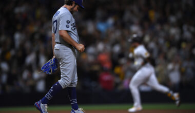 Jun 23, 2021; San Diego, California, USA; Los Angeles Dodgers starting pitcher Trevor Bauer (left) looks on from the mound after a home run hit by San Diego Padres catcher Victor Caratini (right) during the seventh inning at Petco Park. Mandatory Credit: Orlando Ramirez-USA TODAY Sports