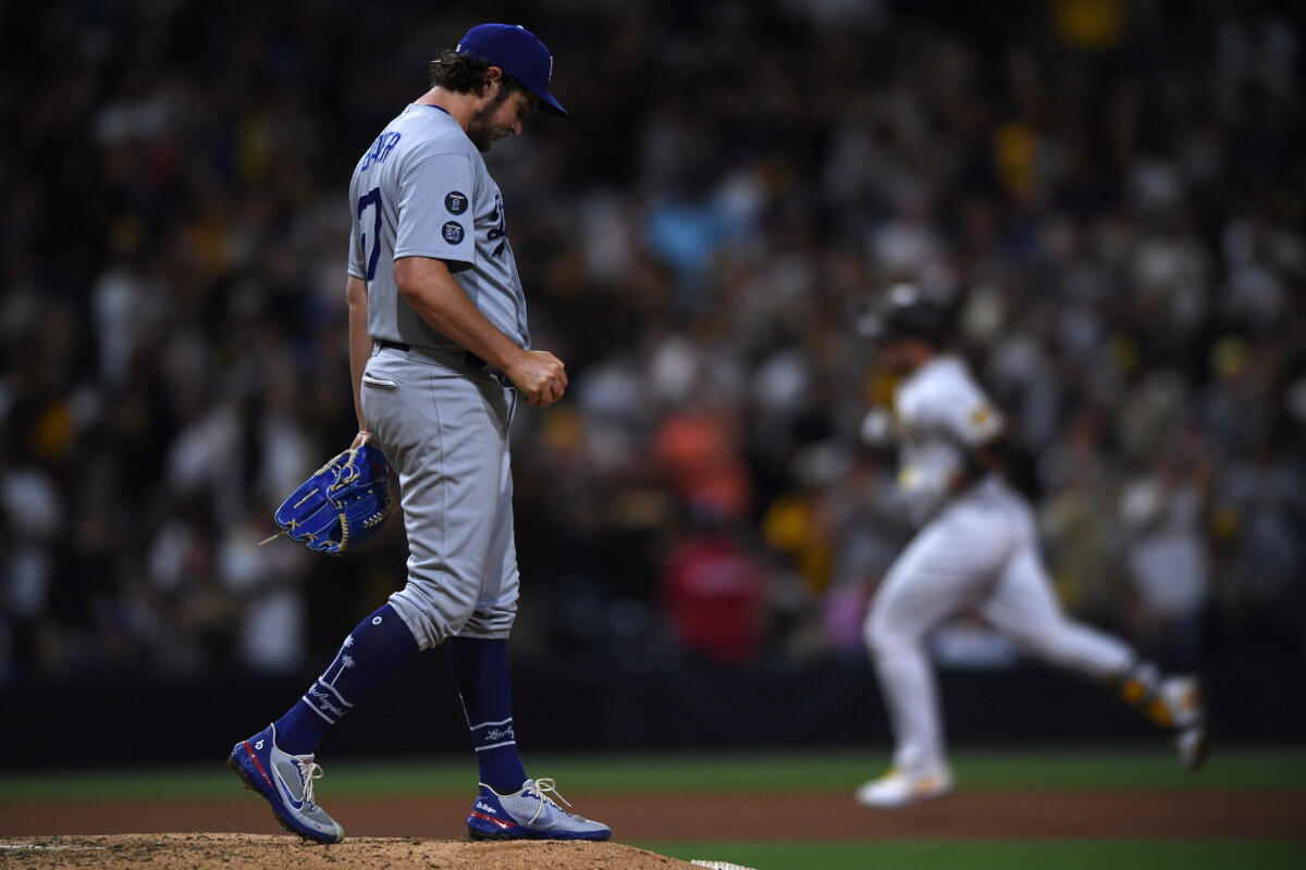Jun 23, 2021; San Diego, California, USA; Los Angeles Dodgers starting pitcher Trevor Bauer (left) looks on from the mound after a home run hit by San Diego Padres catcher Victor Caratini (right) during the seventh inning at Petco Park. Mandatory Credit: Orlando Ramirez-USA TODAY Sports