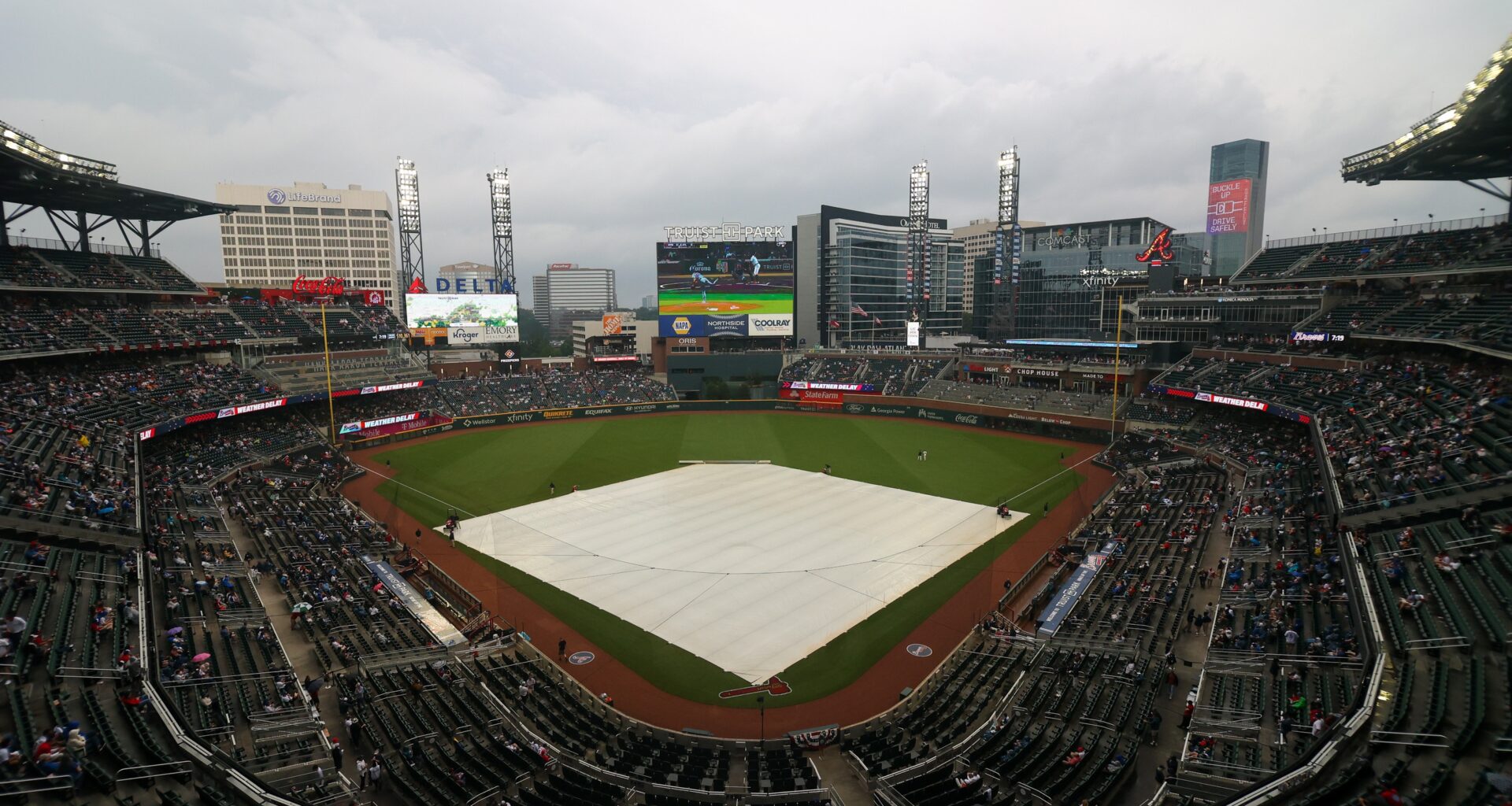 May 22, 2023; Atlanta, Georgia, USA; The tarp covers the field at Truist Park during a rain delay before a game between the Atlanta Braves and Los Angeles Dodgers. Mandatory Credit: Brett Davis-USA TODAY Sports