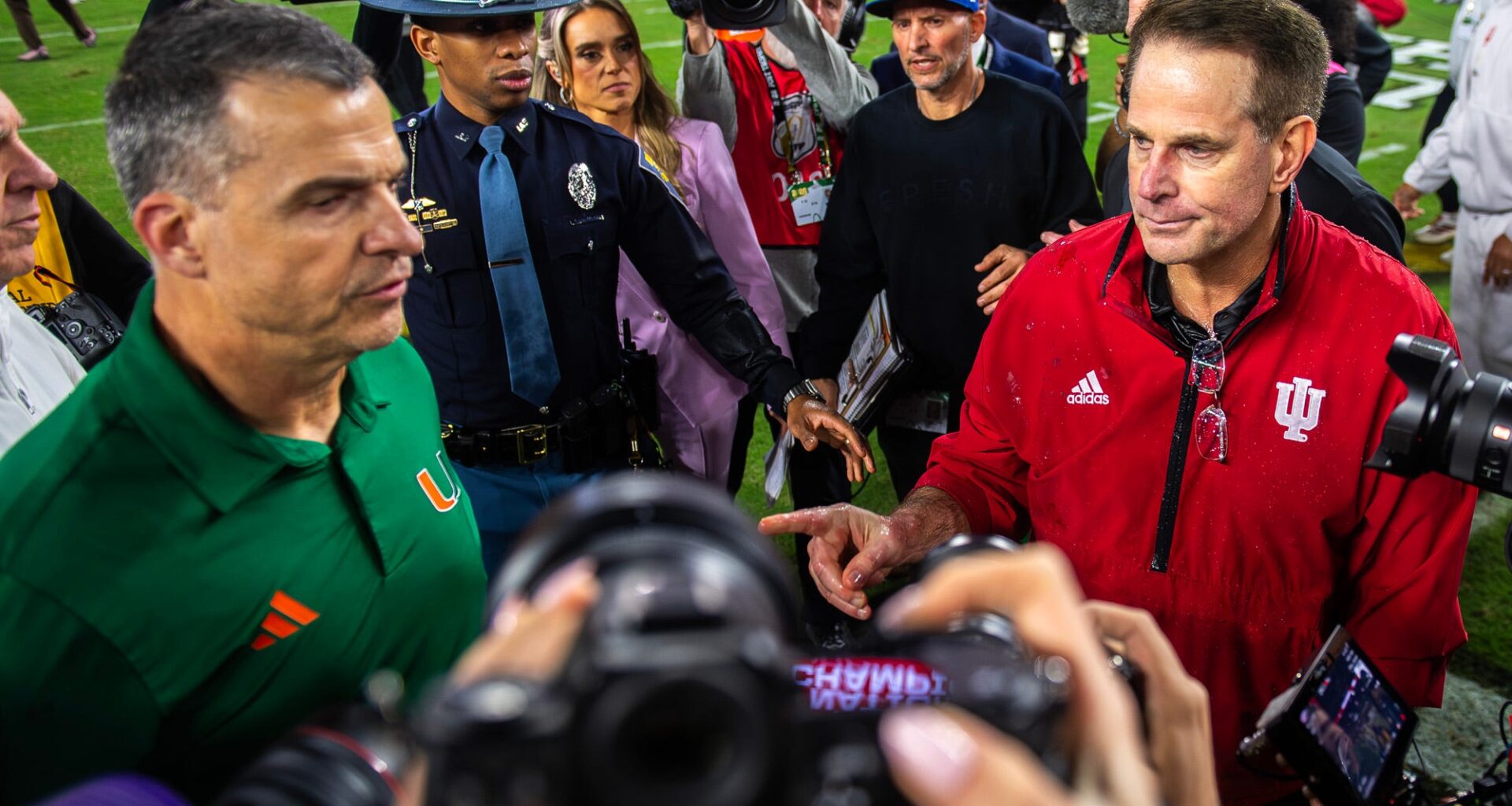 Miami head coach Mario Cristobal greets Indiana head coach Curt Cignetti after loss in the national championship