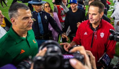 Miami head coach Mario Cristobal greets Indiana head coach Curt Cignetti after loss in the national championship