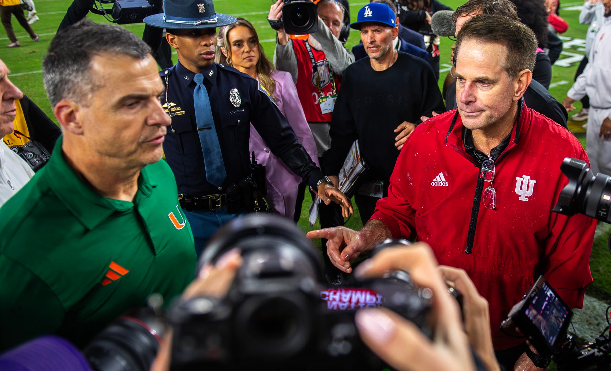 Miami head coach Mario Cristobal greets Indiana head coach Curt Cignetti after loss in the national championship