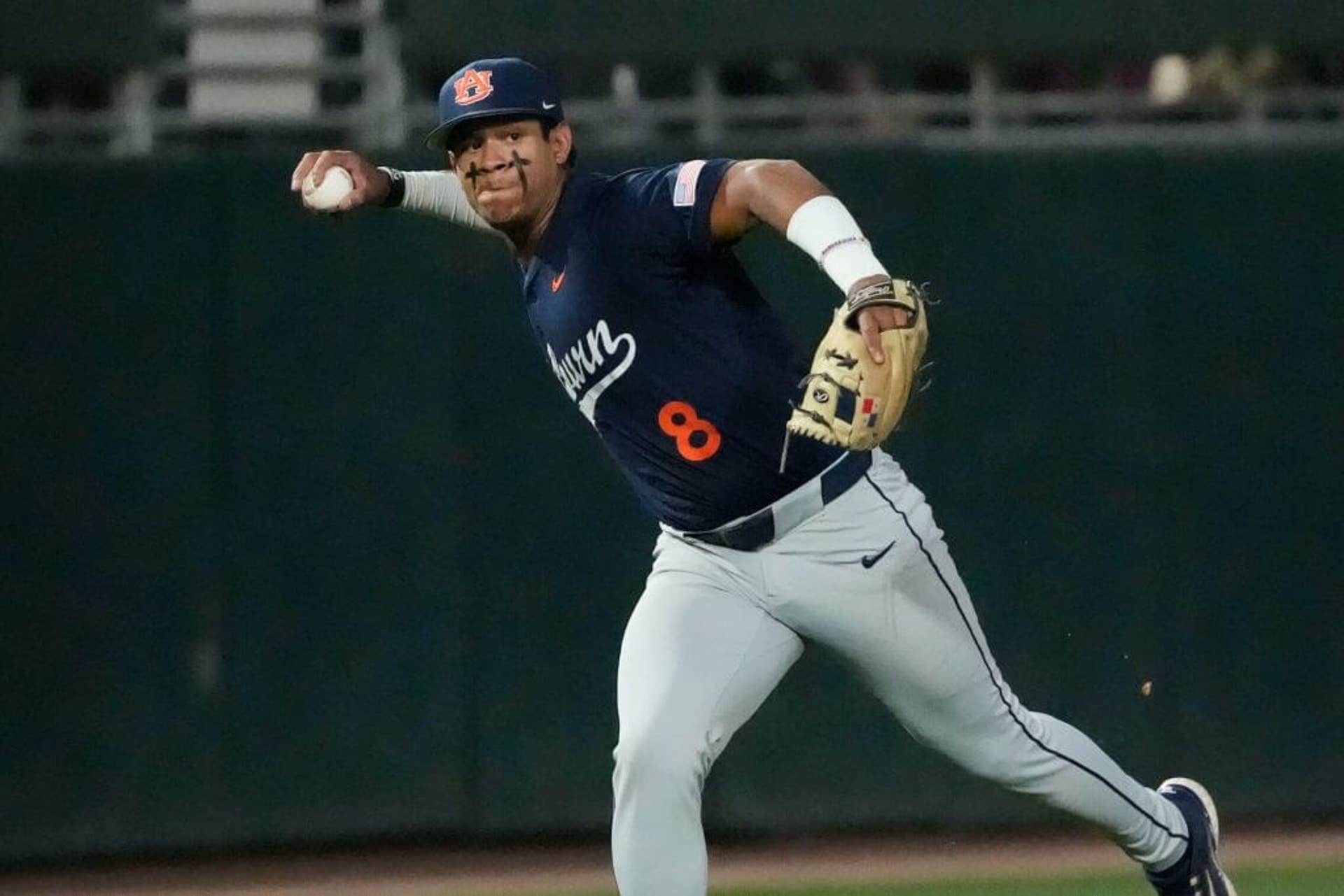 Auburn third baseman Eric Guevara throws the ball to first.