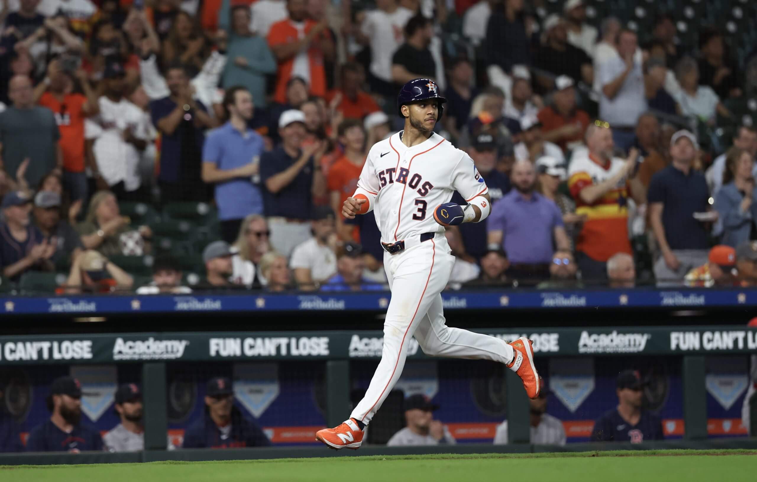Jeremy Peña, wearing No. 3 on his jersey, runs and looks to his left as he scores on designated hitter Yordan Alvarez’s RBI double against the Boston Red Sox.