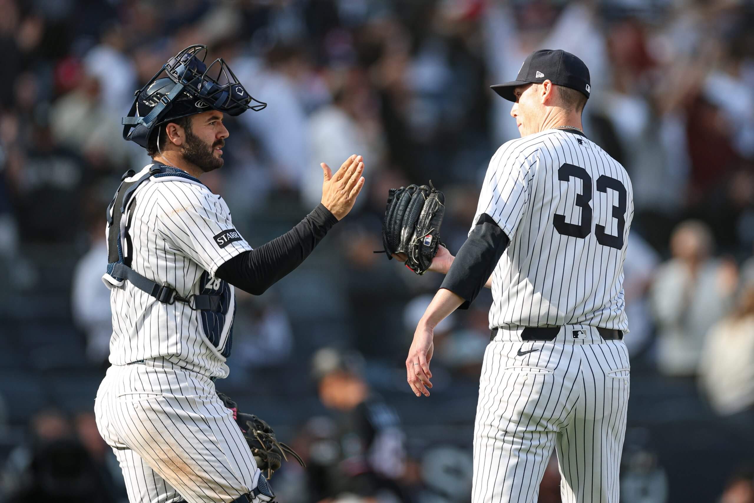 New York Yankees pitcher Ryan Yarbrough (33) celebrates with catcher Austin Wells (28) after defeating the Miami Marlins at Yankee Stadium.