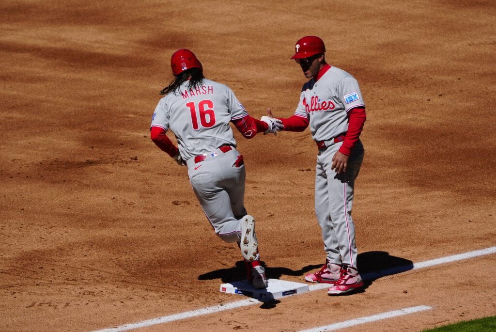 Apr 3, 2026; Denver, Colorado, USA; Philadelphia Phillies center fielder Brandon Marsh (16) celebrates his three run home run with first base coach Paco Figueroa (38) in the first inning against the Philadelphia Phillies at Coors Field.