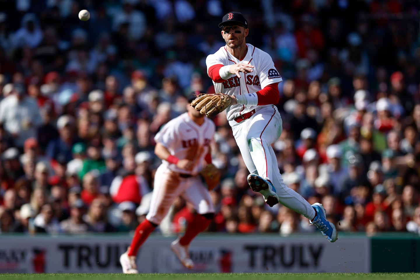 Shortstop Trevor Story throws to first base for an out in the fifth inning.