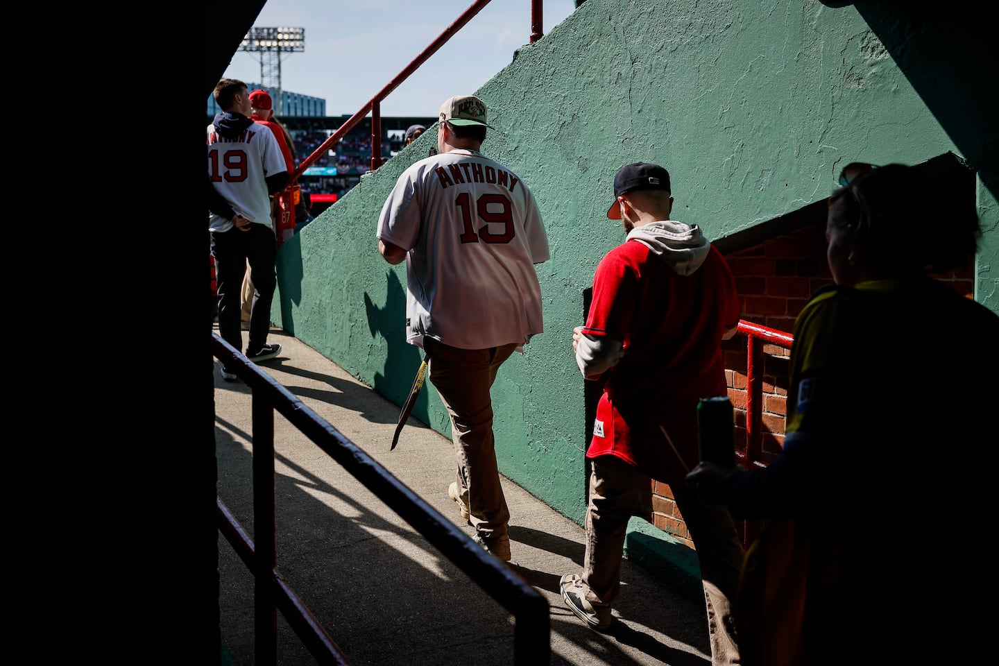 Fans walk up a ramp toward their seats.