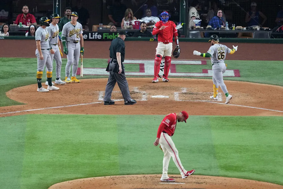 Texas Rangers starting pitcher Nathan Eovaldi, bottom, reacts after giving up a three run home run to Athletics' <a class="link " href="https://sports.yahoo.com/mlb/players/12488/" data-i13n="sec:content-canvas;subsec:anchor_text;elm:context_link" data-ylk="slk:Carlos Cortes;sec:content-canvas;subsec:anchor_text;elm:context_link;itc:0" data-yga="{"yLinkElement":"context_link","yModuleName":"content-canvas","yLinkText":"Carlos Cortes","ySubModuleName":"anchor_text","yHasCommerce":false}">Carlos Cortes</a> (26) during the fifth inning of a baseball game Friday, April 24, 2026, in Arlington, <a class="link " href="https://sports.yahoo.com/mlb/teams/texas/" data-i13n="sec:content-canvas;subsec:anchor_text;elm:context_link" data-ylk="slk:Texas;sec:content-canvas;subsec:anchor_text;elm:context_link;itc:0" data-yga="{"yLinkElement":"context_link","yModuleName":"content-canvas","yLinkText":"Texas","ySubModuleName":"anchor_text","yHasCommerce":false}">Texas</a>. (AP Photo/Julio Cortez) (Julio Cortez/AP)