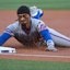 New York Mets shortstop Francisco Lindor (12) slides safely in at third.