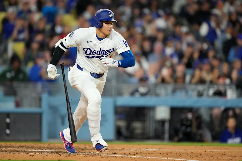 Los Angeles Dodgers' Shohei Ohtani heads to first for a single during the fifth inning of a baseball game against the Texas Rangers, Friday, April 10, 2026, in Los Angeles. (AP Photo/Mark J. Terrill)