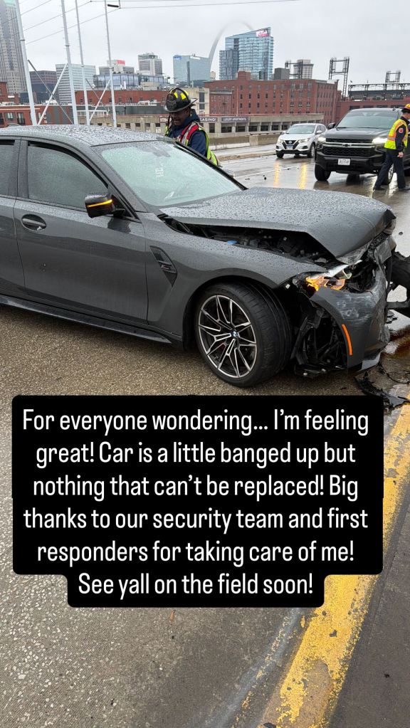 Damaged gray car with extensive front-end collision damage, with the caption: "For everyone wondering... I'm feeling great! Car is a little banged up but nothing that can't be replaced! Big thanks to our security team and first responders for taking care of me! See yall on the field soon!"