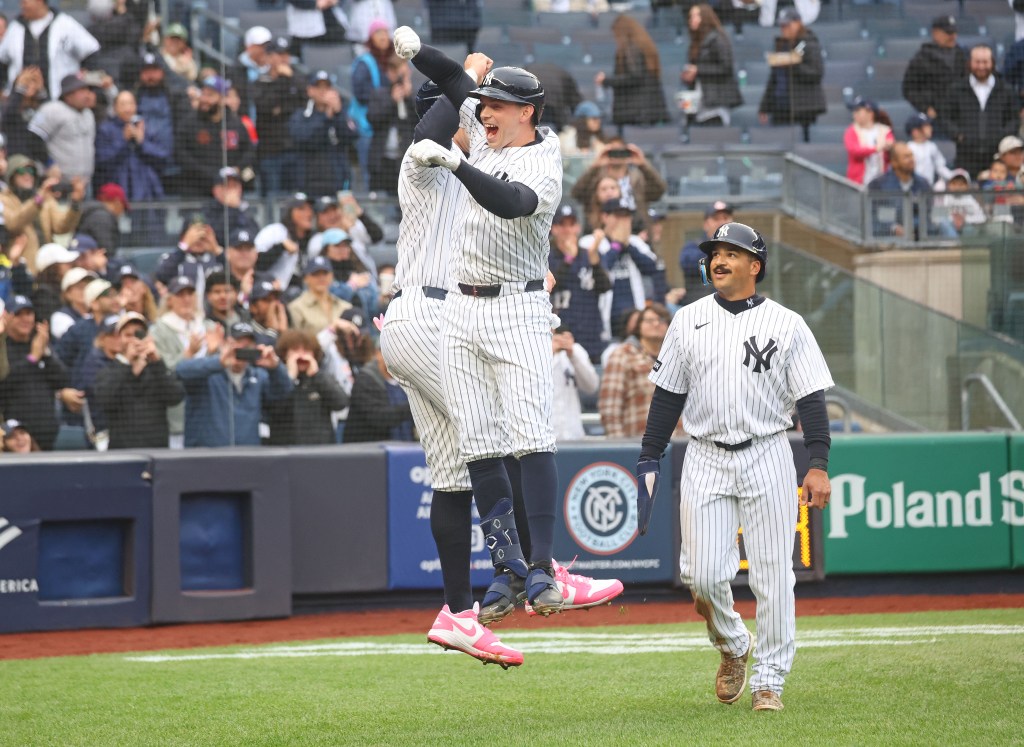 New York Yankees first baseman Ben Rice (22) celebrates with New York Yankees right fielder Aaron Judge (99) after he scores on his three-run homer.