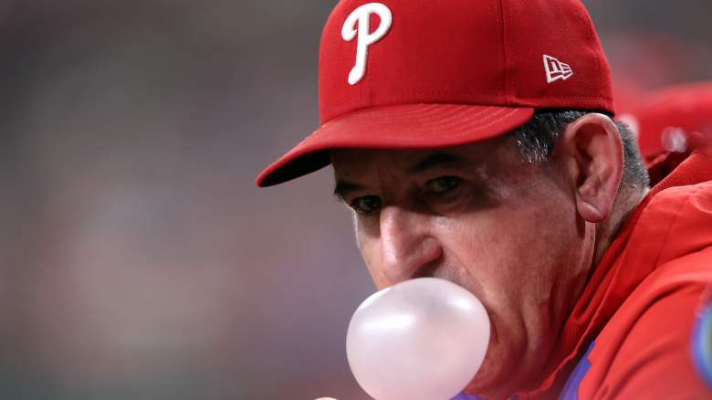 Philadelphia Phillies manager Rob Thomson blows a bubble as the team signs South Korean pitcher Chan-min Park.