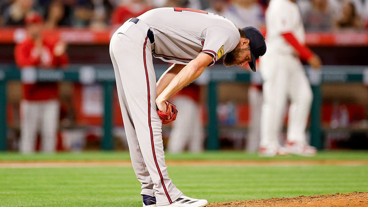 Atlanta Braves starter Chris Sale reacting after hitting Los Angeles Angels designated hitter Yoan Moncada with a pitch