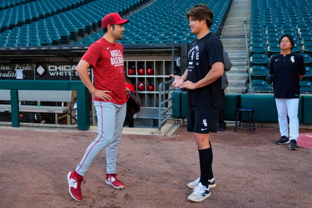 Los Angeles Angels' Yusei Kikuchi, left, and Chicago White Sox's Munetaka Murakami greet each other before a baseball game Tuesday, April 28, 2026, in Chicago. (AP Photo/Erin Hooley)
