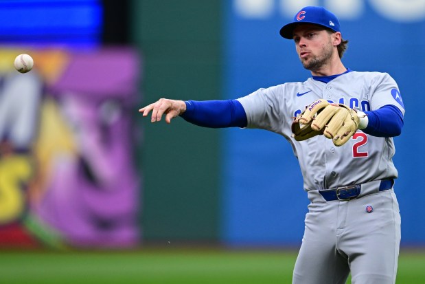 Chicago Cubs second baseman Nico Hoerner throws to first base to get out Cleveland Guardians' Kyle Manzardo during the fourth inning of a baseball game, Sunday, April 5, 2026, in Cleveland. (AP Photo/David Dermer)